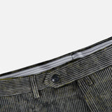 Close-up of the waistband and button of the Malcom Cotton Corduroy Trouser Pant, highlighting refined details against a white background. The black button and visible waistband lining emphasize the craftsmanship of these luxury trousers, expertly made in Italy.