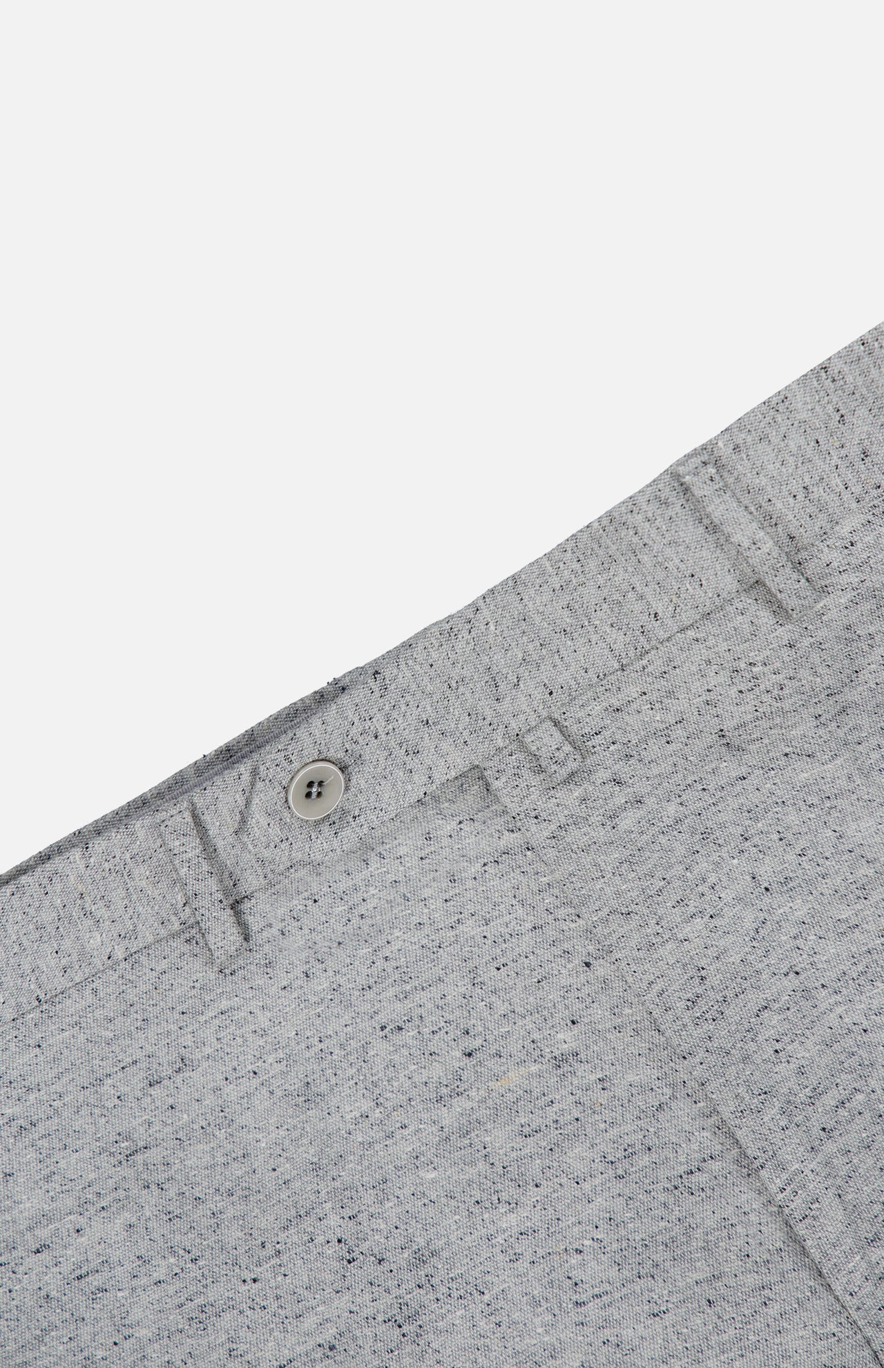 Close-up of the Malcom Wool Silk Donegal Trouser Pant in light grey, highlighting the speckled wool-blend fabric, waistband with button, belt loops, and a portion of the front pocket against a white background.