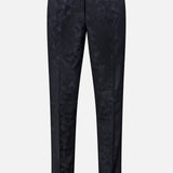 Malcom’s Wool Stretch Trouser Pant features a straight-leg cut and a subtle textured pattern, finished with a front button and zipper closure. Crafted for timeless sophistication, these luxury trousers are showcased against a plain white background.
