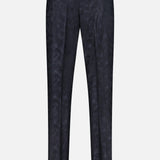 Back view of the Malcom Wool Stretch Trouser Pant in a dark, patterned design, featuring belt loops, two buttoned back pockets, and a tailored fit, displayed on a plain light background.