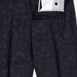 Malcom Wool Stretch Trouser Pant in a dark, subtle feather or foliage print, tailored in a modern tapered fit. The partially open waistband and zipper reveal the inner lining and button closure details, highlighting the luxury craftsmanship reminiscent of fine Italian wool trousers.
