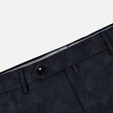 Close-up of the waist area of the Malcom Wool Stretch Trouser Pant, featuring a subtle textured pattern in black, belt loops, a button closure, and part of the waistband—showcasing the refined detailing characteristic of these luxury trousers.