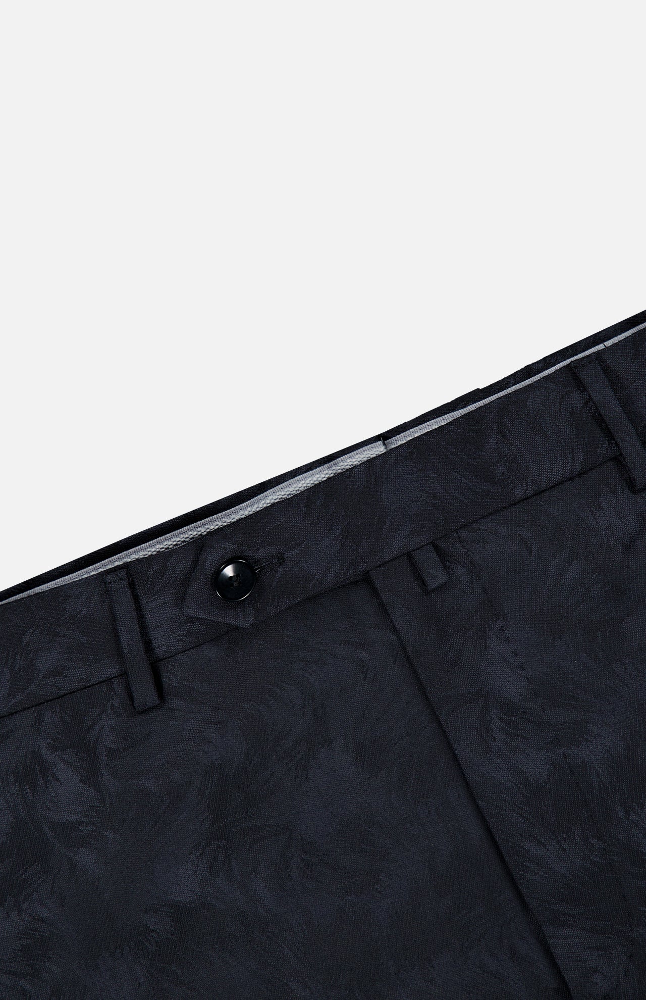 Close-up of the waist area of the Malcom Wool Stretch Trouser Pant, featuring a subtle textured pattern in black, belt loops, a button closure, and part of the waistband—showcasing the refined detailing characteristic of these luxury trousers.