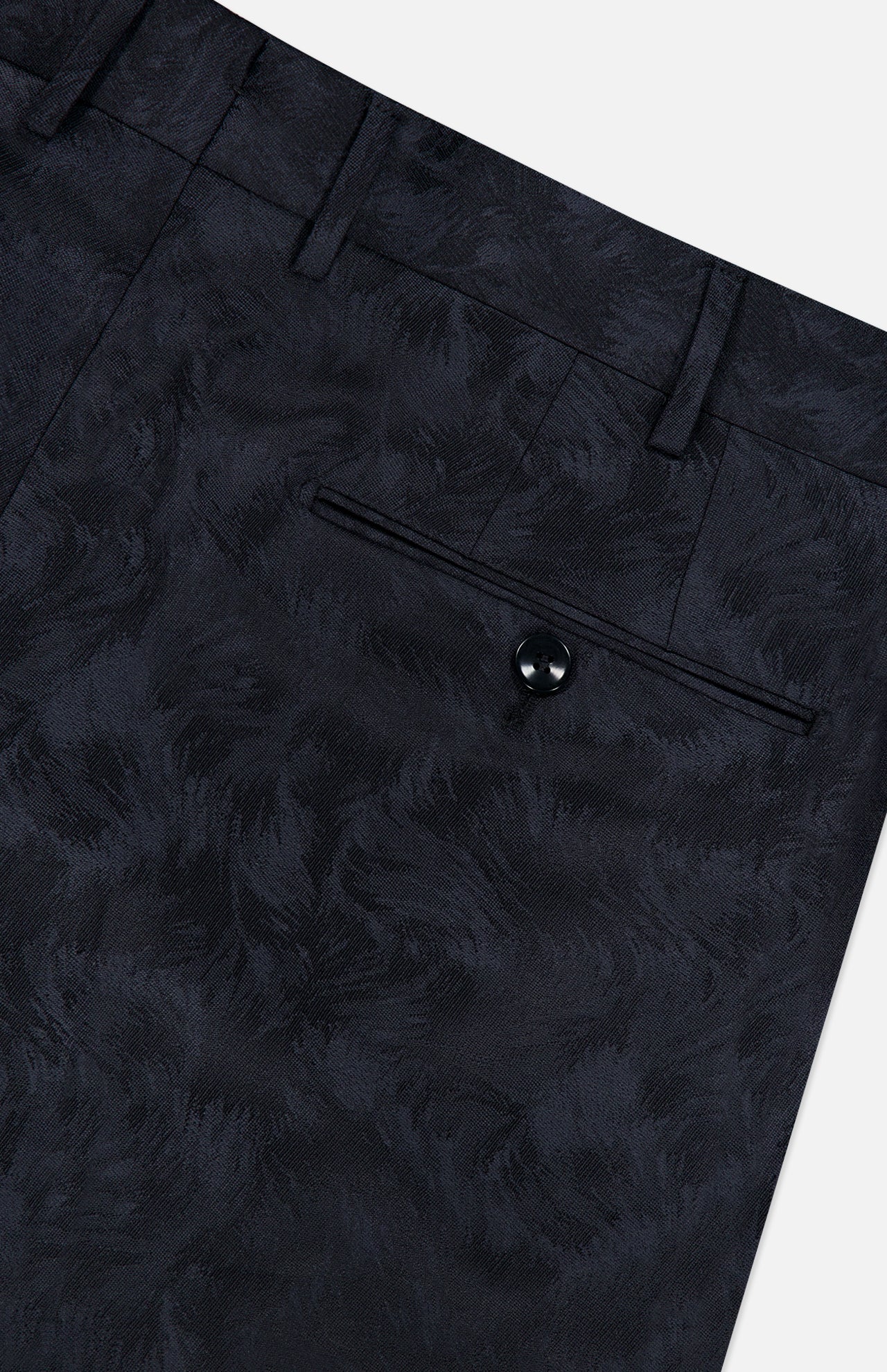 Close-up of the Malcom Wool Stretch Trouser Pant, featuring a subtle leaf pattern with detailed shots of the waistband, belt loops, and a buttoned back pocket.