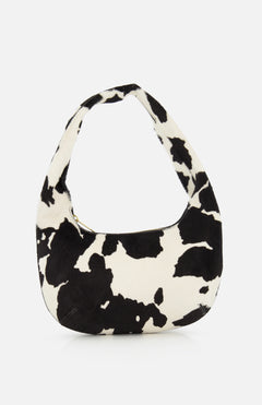 The MANSUR GAVRIEL Mini Gnocchi Cow Print Bag features a black and white animal print, a curved hobo silhouette, and a top zipper closure.
