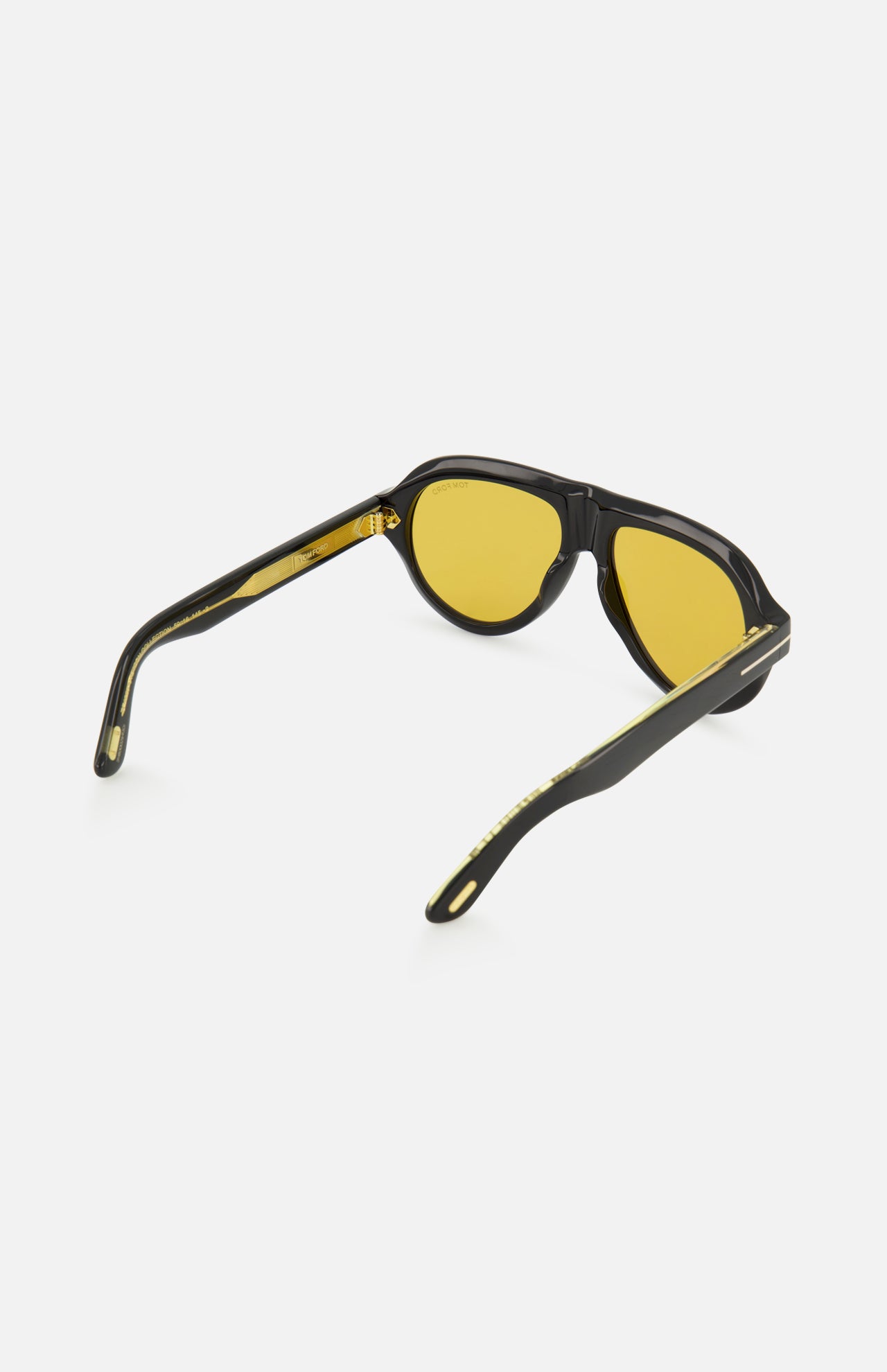 Tom Ford Icon Pilot sunglasses with black aviator acetate frames, gold-tone temple accents, and yellow lenses.