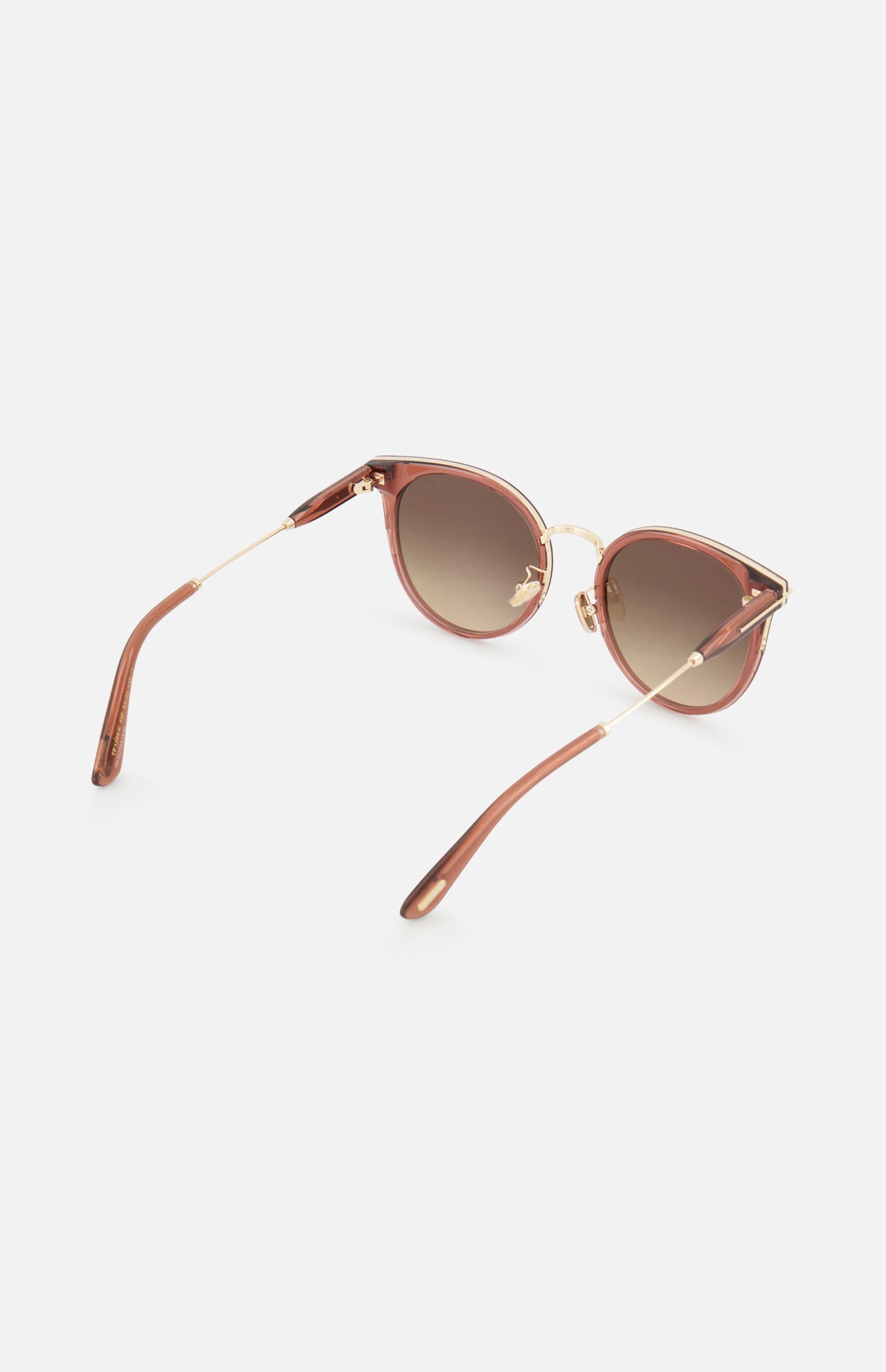 Tom Ford Round Light Brown Sunglasses with light brown gradient lenses, thin gold-tone metal temples, and light brown rims.