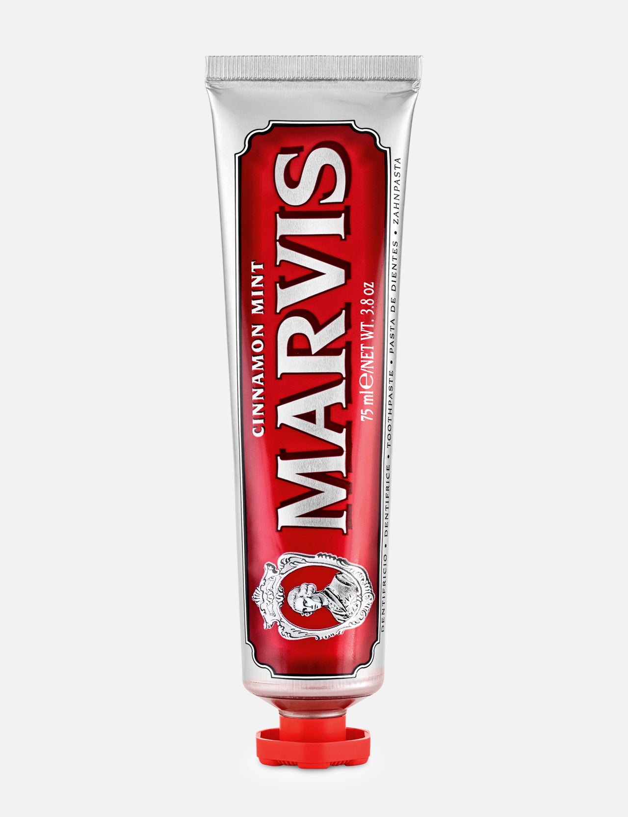 A red and silver tube of MARVIS Cinnamon Mint Toothpaste stands upright with a red cap, showcasing ornate design elements and bold white text on the front—an Italian luxury toothpaste that offers a uniquely refreshing cinnamon mint flavor.