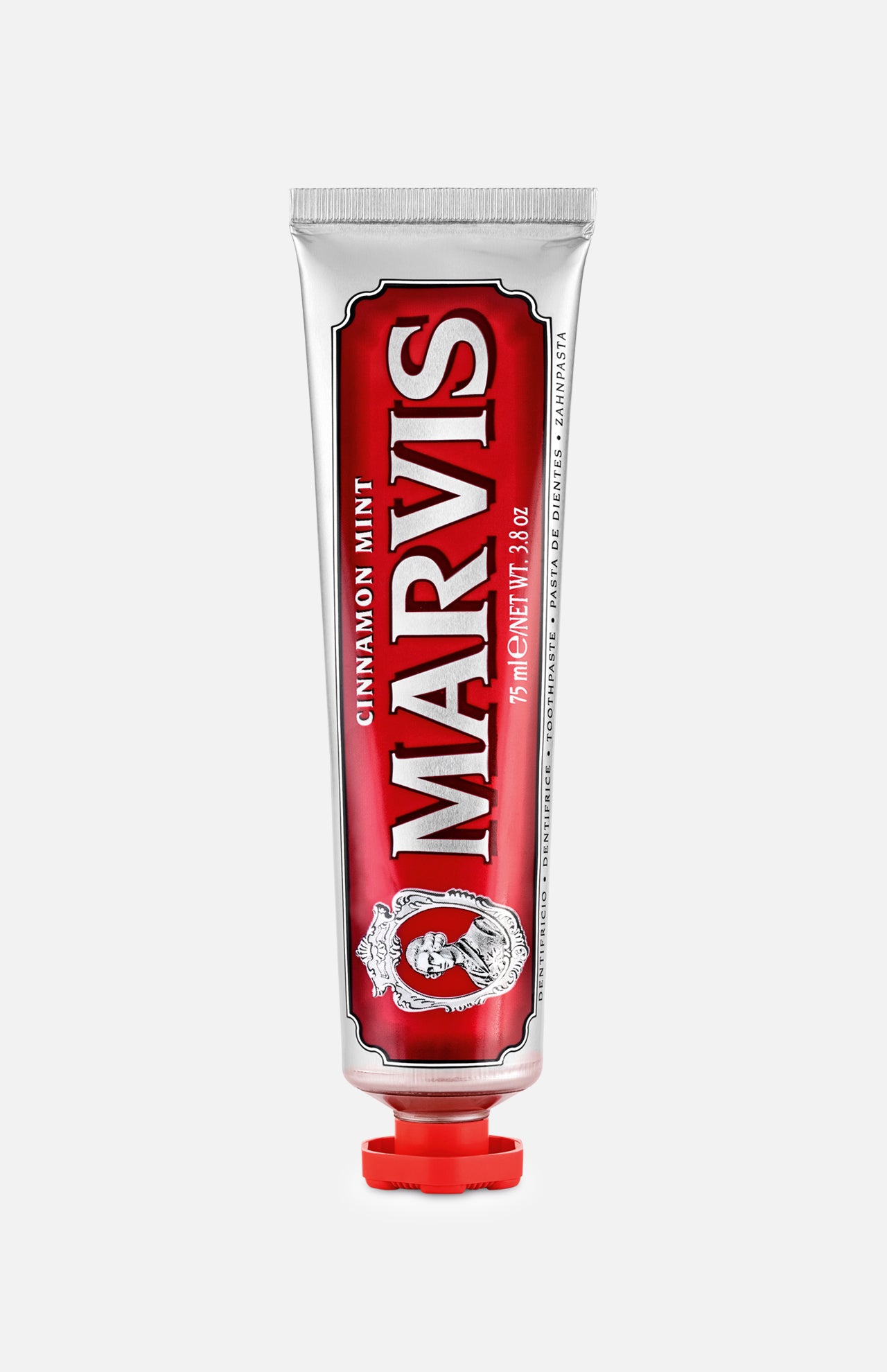 A red and silver tube of MARVIS Cinnamon Mint Toothpaste stands upright with a red cap, showcasing ornate design elements and bold white text on the front—an Italian luxury toothpaste that offers a uniquely refreshing cinnamon mint flavor.