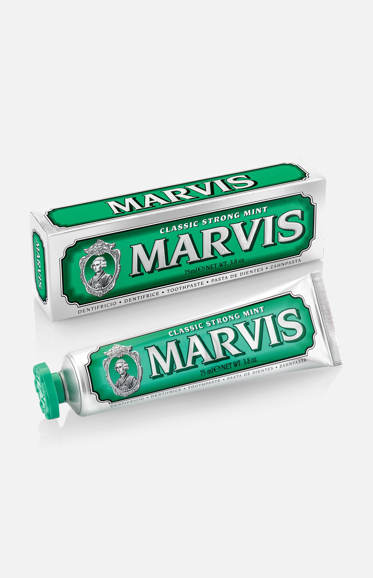 A tube of MARVIS Classic Strong Mint Toothpaste, in green and white, is displayed alongside its coordinating box—both adorned with the MARVIS logo and signature decorative details. This Italian-made toothpaste offers a concentrated formula that provides the bold, classic strong mint flavor for a refreshing clean.
