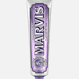 A silver tube of MARVIS Jasmin Mint Toothpaste, crafted in Italy, stands upright against a plain white background, distinguished by its purple accents and matching purple cap.