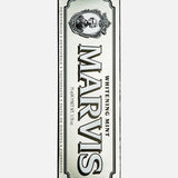 A box of MARVIS Whitening Mint Toothpaste, silver in color, featuring a vintage-style label and an illustration of a person in an oval frame at the top. This Italian-made toothpaste by MARVIS delivers a refreshing approach to teeth whitening while adding elegance to your daily routine.