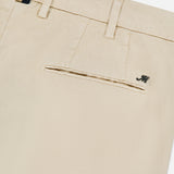 Close-up of MASON'S NY Linen Cotton Trouser Pant in cream, highlighting the back pocket with a metallic M logo, belt loops, and a glimpse of patterned fabric inside the waistband.