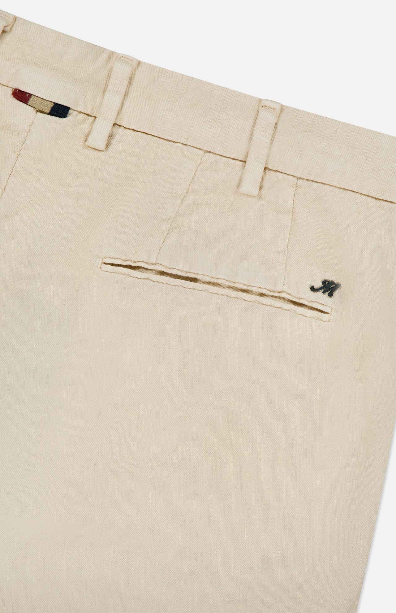 Close-up of MASON'S NY Linen Cotton Trouser Pant in cream, highlighting the back pocket with a metallic M logo, belt loops, and a glimpse of patterned fabric inside the waistband.