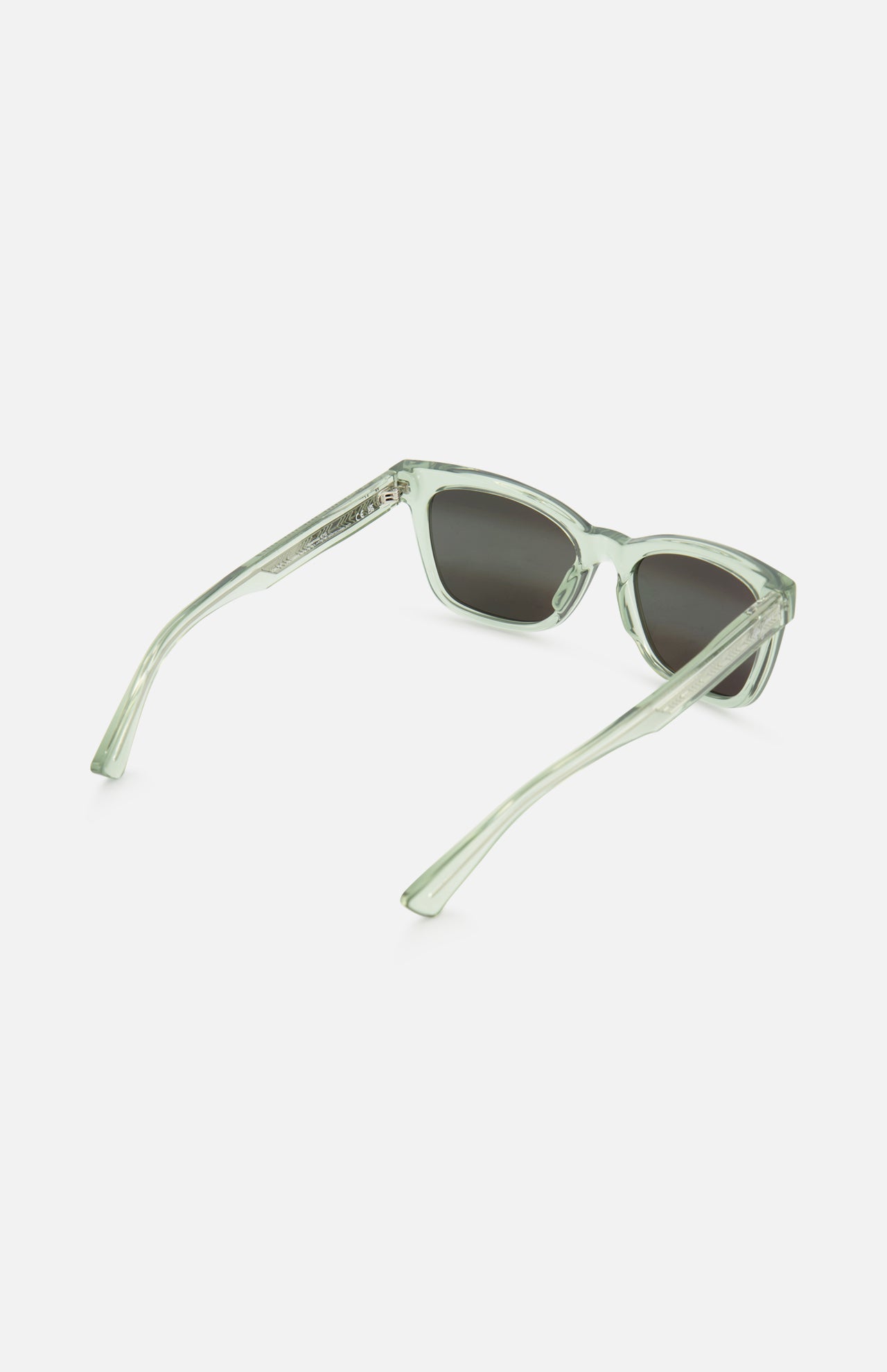 MAUI JIM Hiwahiwa Butterfly Green Sunglasses feature square polarized dark lenses and translucent light green frames, shown on a white background at an angle revealing both front and side views.