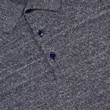 Close-up of the MAURIZIO BALDASSARI Front Stitch 3B Polo Shirt in textured gray linen-blend, featuring three dark buttons and a visible “Made in Italy” label near the collar.