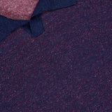 Close-up of the MAURIZIO BALDASSARI Light Bicolor Johnny Collar Polo Shirt, featuring a textured linen blend in dark blue with red flecks, a signature collar, and a partially visible Made in Italy label.