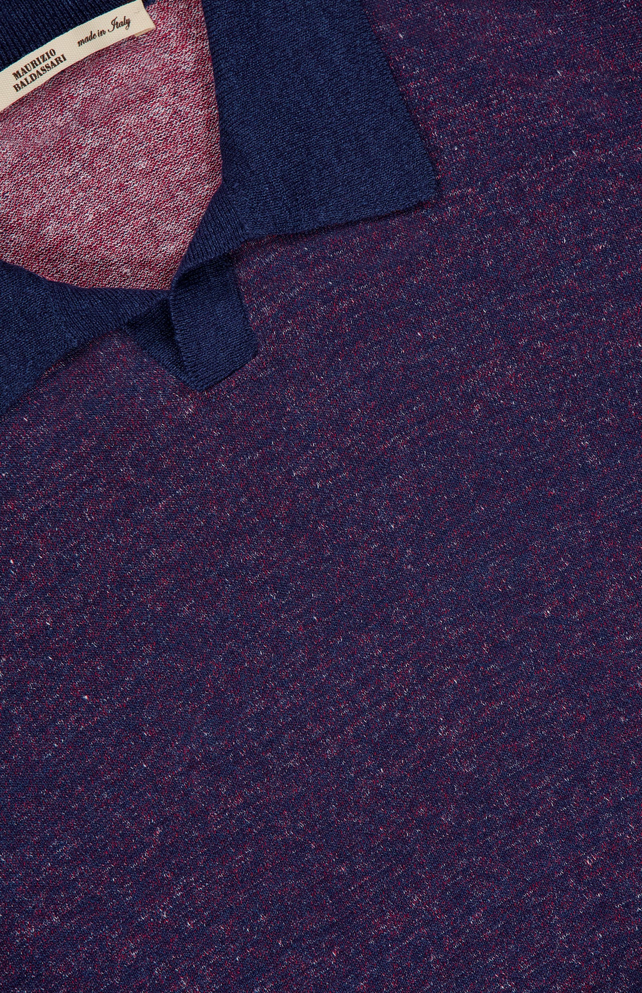 Close-up of the MAURIZIO BALDASSARI Light Bicolor Johnny Collar Polo Shirt, featuring a textured linen blend in dark blue with red flecks, a signature collar, and a partially visible Made in Italy label.