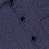 Close-up of the Light Classic Overshirt by MAURIZIO BALDASSARI, made in Italy. This dark blue piece features black buttons, a visible right chest pocket, and subtly textured fabric.