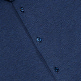 Close-up of the Santini Spread Collar Shirt by MAURIZIO BALDASSARI, featuring its refined collar, buttons, and textured blue fabric—ideal for smart casual settings. A label in the top left corner indicates this stylish navy shirt is crafted in Italy.