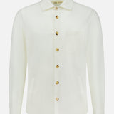 The Solferino Wool Overshirt by MAURIZIO BALDASSARI is a long-sleeve, off-white overshirt crafted in Italy from luxurious virgin wool. It features a classic collar, front chest pocket, and distinctive brown buttons, and is displayed on a plain white background.