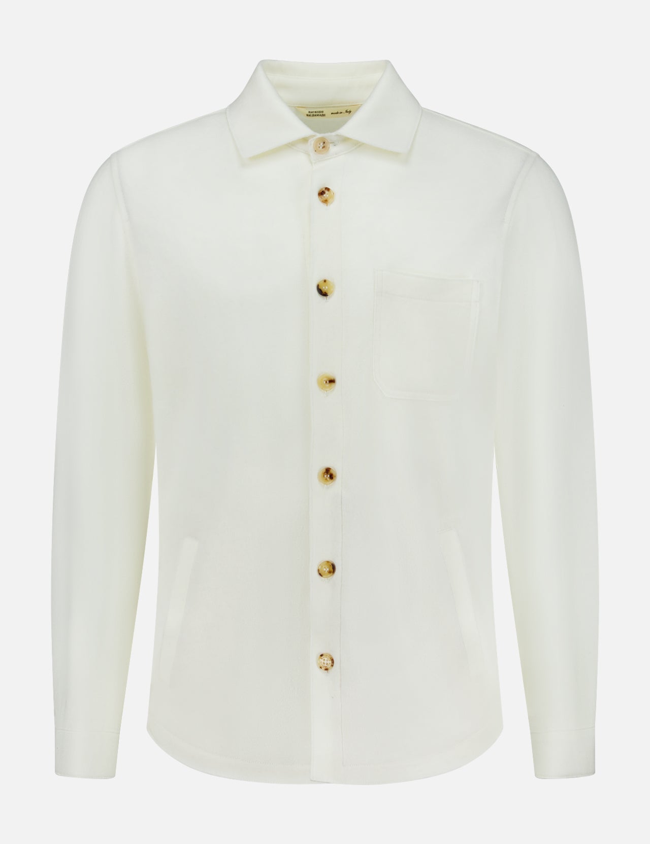 The Solferino Wool Overshirt by MAURIZIO BALDASSARI is a long-sleeve, off-white overshirt crafted in Italy from luxurious virgin wool. It features a classic collar, front chest pocket, and distinctive brown buttons, and is displayed on a plain white background.