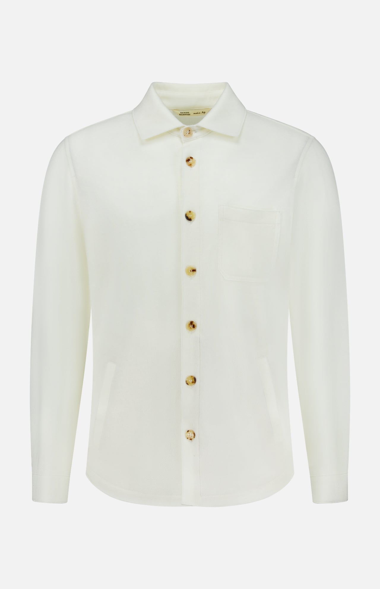 The Solferino Wool Overshirt by MAURIZIO BALDASSARI is a long-sleeve, off-white overshirt crafted in Italy from luxurious virgin wool. It features a classic collar, front chest pocket, and distinctive brown buttons, and is displayed on a plain white background.