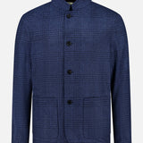 The Stendhal Stand Collar 4 Button Jacket by MAURIZIO BALDASSARI is a men’s blue checkered blazer featuring a stand collar, four front buttons, and two front pockets. Made in Italy, it is shown against a plain white background.