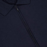 Close-up of the MAURIZIO BALDASSARI Tennis Details Zip Sweater in navy, featuring a center zip-up collar and a visible "made in Italy" label at the neckline. The fabric appears soft and finely knit.