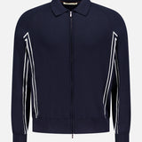The Tennis Details Zip Sweater by MAURIZIO BALDASSARI is a navy zip-up with a collar, long sleeves, and white diagonal stripes. Made in Italy, it features a minimal design with ribbed cuffs and hem.