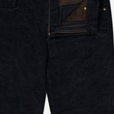 A close-up of the Treves Five Pocket Corduroy Pants by MAURIZIO BALDASSARI in black, featuring an unzipped fly that reveals a brown inner lining and gold buttons. Expertly crafted in Italy, these pants showcase refined craftsmanship and timeless style.