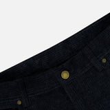 Close-up of the waist area of a pair of deep navy corduroy pants with a sturdy button closure, belt loops, and a visible front pocket against a white background—expertly crafted details that reflect the same dedication to quality found in MAURIZIO BALDASSARI’s Treves Five Pocket Corduroy Pants.