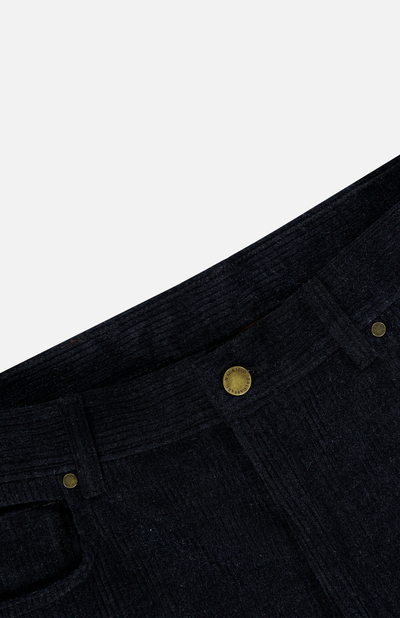 Close-up of the waist area of a pair of deep navy corduroy pants with a sturdy button closure, belt loops, and a visible front pocket against a white background—expertly crafted details that reflect the same dedication to quality found in MAURIZIO BALDASSARI’s Treves Five Pocket Corduroy Pants.