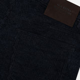 Close-up of the MAURIZIO BALDASSARI Treves Five Pocket Corduroy Pants in black, featuring a detailed view of the back pocket and a black leather patch with embossed, partially readable text on the waistband. The visible fabric texture and precise stitching showcase the refined Italian craftsmanship.