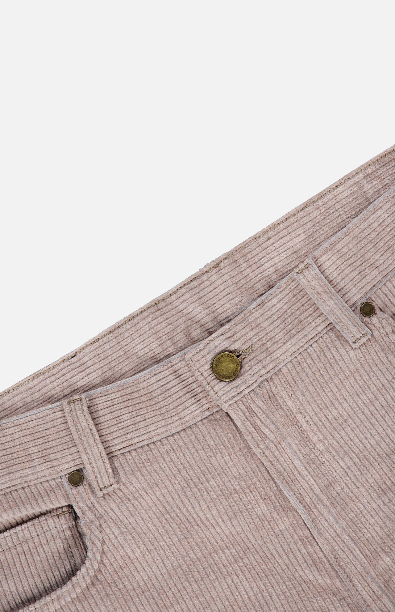 Close-up of the waistband and front pockets of the MAURIZIO BALDASSARI Treves Five Pocket Corduroy Pants in light beige, made in Italy, featuring a brass button and belt loops, laid flat against a white background.