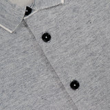 Close-up of the MAURIZIO BALDASSARI Millerighe Milano Stitch Overshirt in light grey virgin wool linen, featuring a white-trimmed collar, black buttons, textured weave, and a visible "made in Italy" shirt label inside the collar.