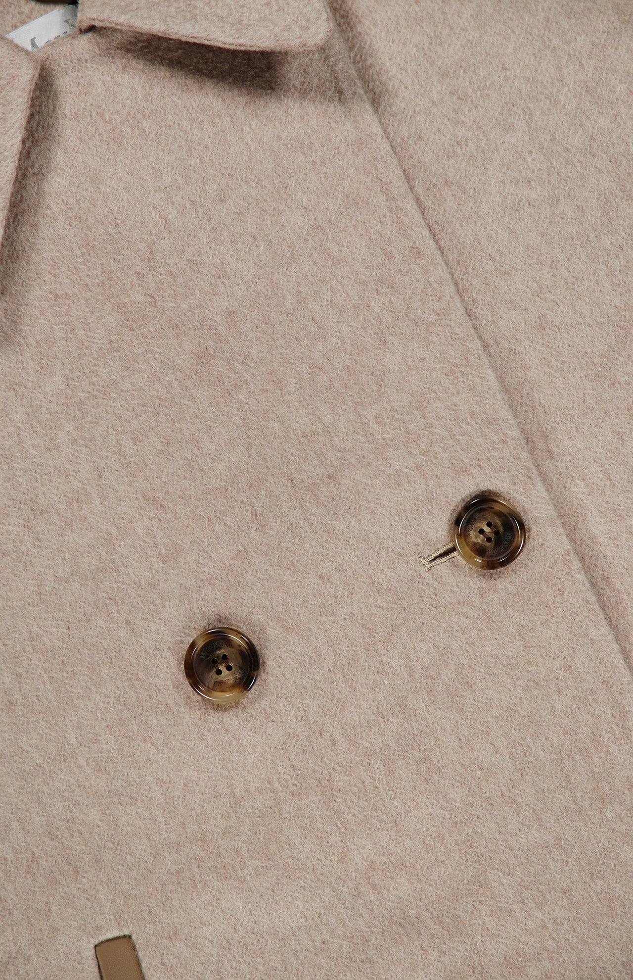 Close-up of the Cashmere Button Sleeve Cape Jacket by MAX MARA in beige, showcasing its double-breasted silhouette with two brown buttons and a partial view of the collar. The soft, textured cashmere fabric adds to its luxurious appearance.