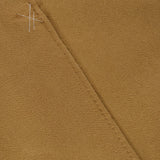 Close-up of light brown suede fabric from the MAX MARA Cashmere Trench Coat, showing a diagonal seam and visible white basting stitches near the top left corner.