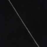Close-up of black textured fabric from the MAX MARA Cashmere Zip Sleeve Short Coat, highlighting a diagonal seam with visible stitching.