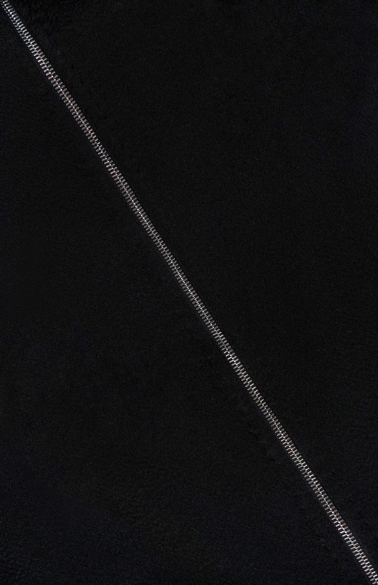 Close-up of black textured fabric from the MAX MARA Cashmere Zip Sleeve Short Coat, highlighting a diagonal seam with visible stitching.