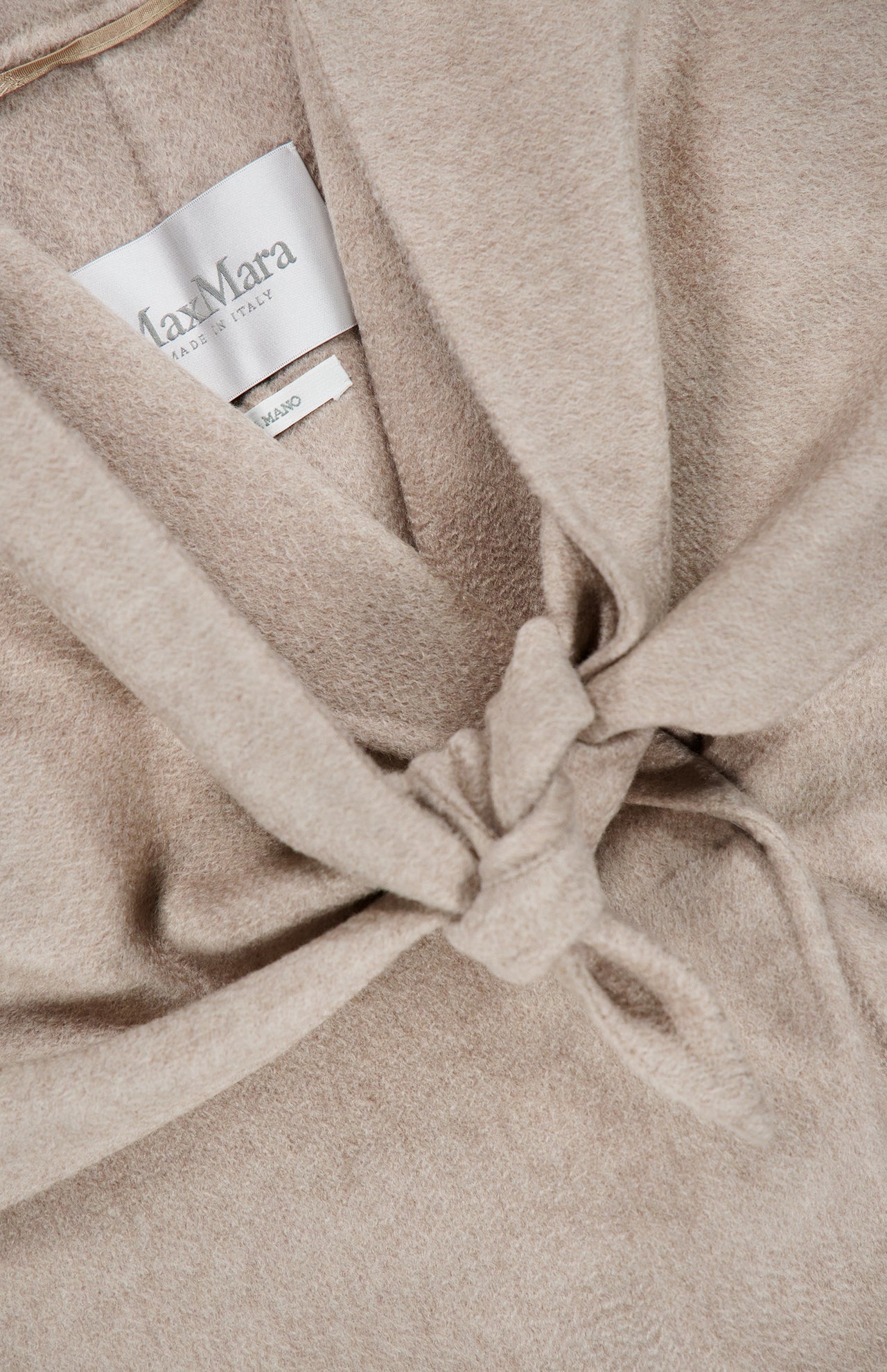 A close-up of a beige MAX MARA Long Cashmere Jacket with Bonus Scarf, made in Italy, featuring a tied knot detail at the front. The MAX MARA label is visible inside the collar.