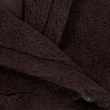 Close-up of a MAX MARA Long Teddy Coat, featuring a dark brown fuzzy texture with a double-breasted front and two visible buttons.