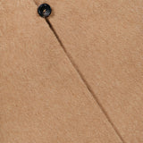 Close-up of a tan Short Wrap Coat with Belt, featuring a single visible button on the front placket.