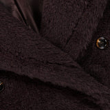 Close-up of a dark brown Max Mara Teddy Short Coat with a fuzzy texture, featuring dark horn buttons and a smooth, logo-patterned lining.