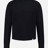 A Merz B. Schwanen Cotton Thermal Long Sleeve T-shirt is displayed on a plain white background. Made from organic cotton, this black crewneck shirt features a minimalist design with long sleeves and is accented by a small white tag near the bottom hem.
