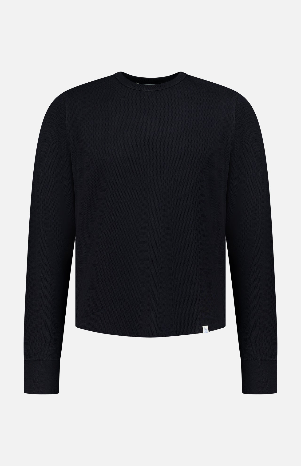 A Merz B. Schwanen Cotton Thermal Long Sleeve T-shirt is displayed on a plain white background. Made from organic cotton, this black crewneck shirt features a minimalist design with long sleeves and is accented by a small white tag near the bottom hem.