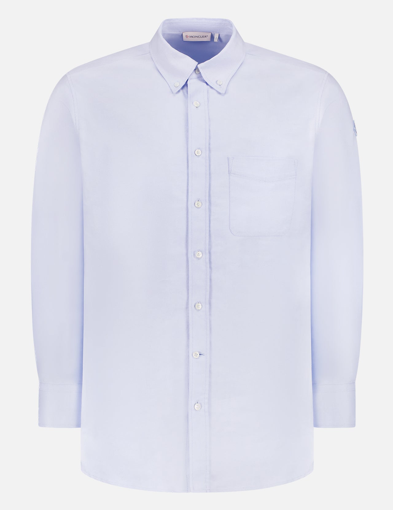 The MONCLER Everyday Cotton Button Up Shirt for men features long sleeves, a classic collar, and a single chest pocket in light blue cotton, shown against a white background.