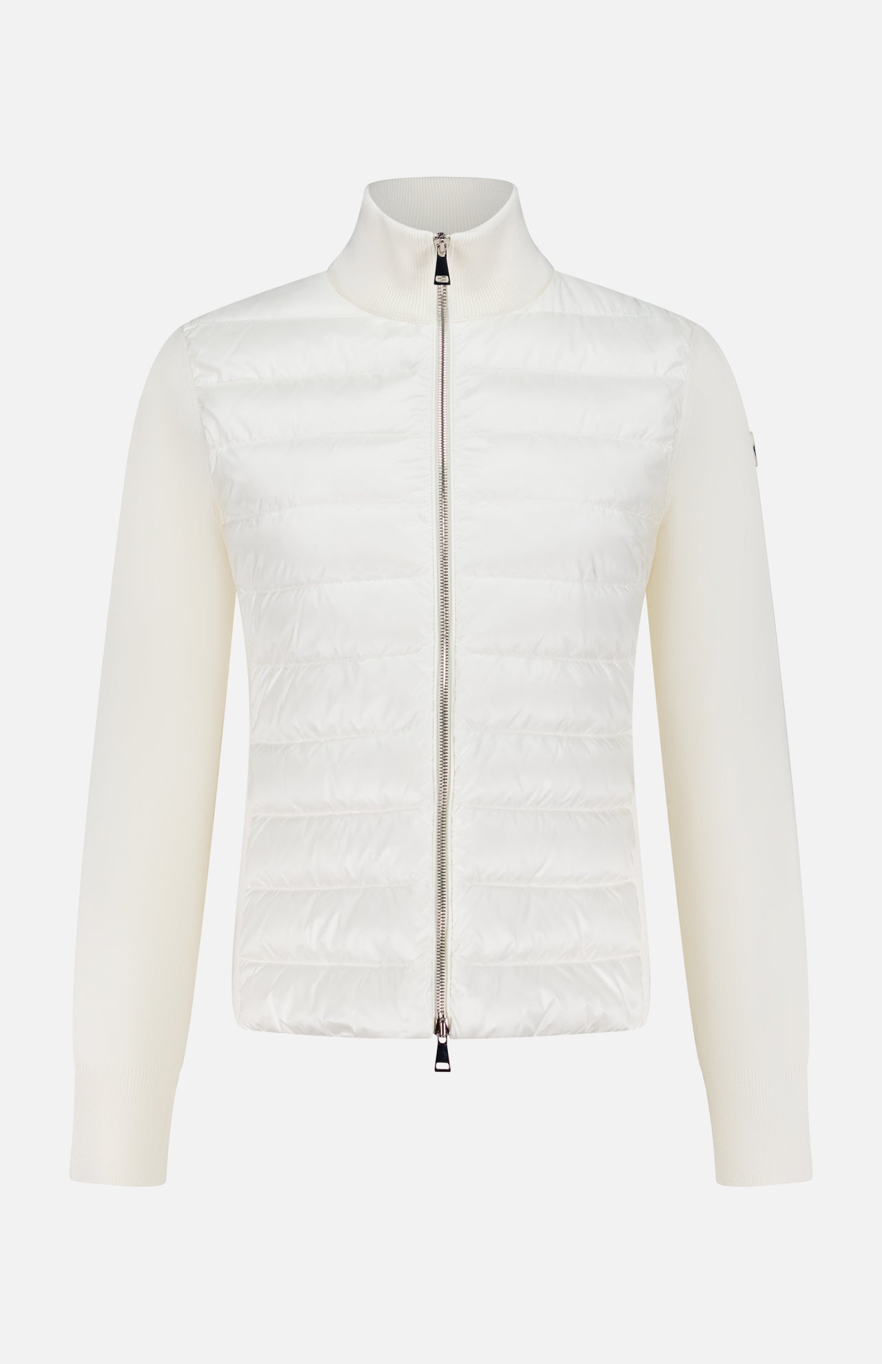 The MONCLER Down Filled Cardigan Jacket is a women’s white knit with a quilted front, ribbed long sleeves, high collar, and a silver zip closure for stylish and chic outerwear.