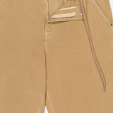A close-up of MONCLER Stretch Cotton Cargo Trouser Pants in tan, with the waistband open to reveal a zipper, button, and drawstring. The smooth fabric features front pockets accented with metal rivets.