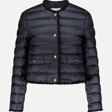 The Fleurs Bouclé Trim Jacket by MONCLER is a black, down-filled, quilted puffer with gold buttons, two front pockets, and no collar. It features long sleeves, is water-repellent, and shown against a plain white background.
